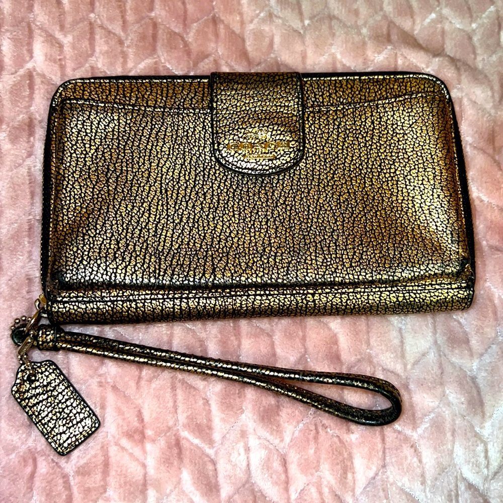 Gold Coach Wristlet wallet with phone carrier to fit up to an iPhone 12.